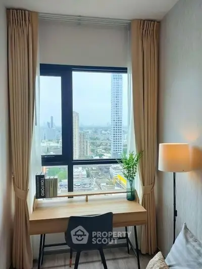 Modern study room with city view, featuring a sleek desk and elegant decor.