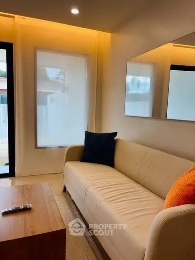 Cozy living room with modern sofa and ambient lighting