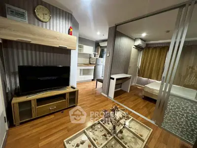 Modern apartment interior with open living room and bedroom, featuring wooden flooring and stylish decor.