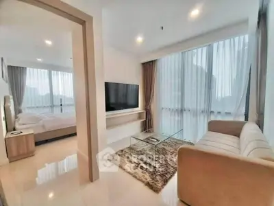Modern living room with glass coffee table and cozy bedroom view