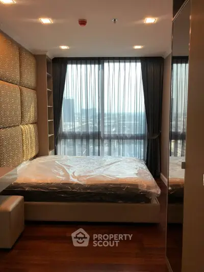 Luxurious bedroom with floor-to-ceiling windows and stunning city view