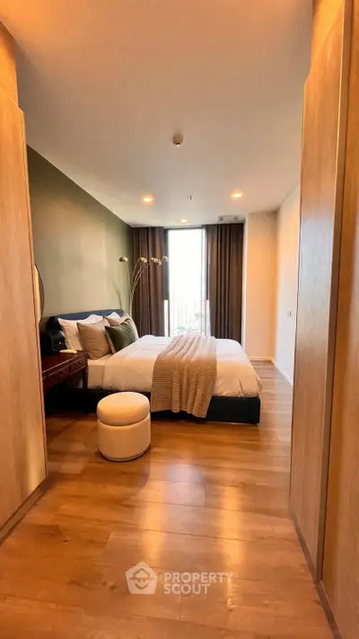 Luxurious bedroom with modern decor and large window offering natural light.