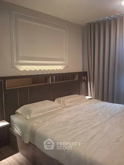 Luxurious bedroom with elegant decor and soft lighting, perfect for relaxation and comfort.