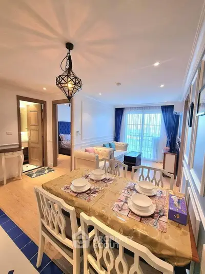 Elegant dining and living area with modern decor and natural light