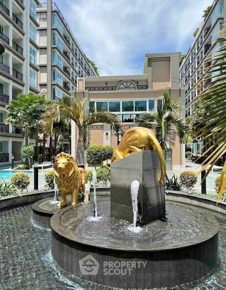 Luxurious apartment complex with elegant fountain and golden lion statues in lush courtyard.