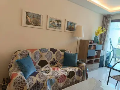 Cozy living room with colorful sofa, modern decor, and balcony access.