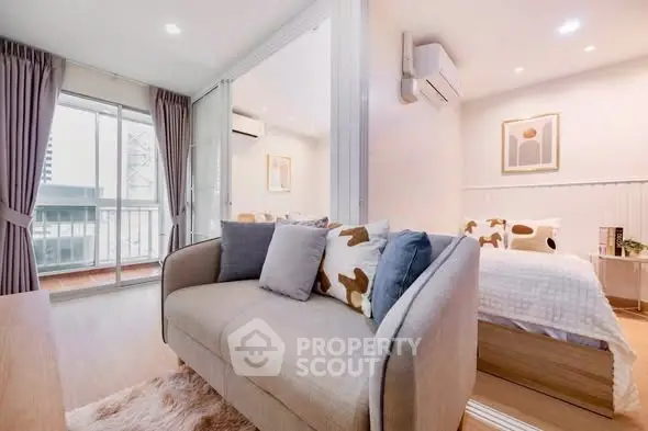 Modern living room with cozy sofa and stylish bedroom view