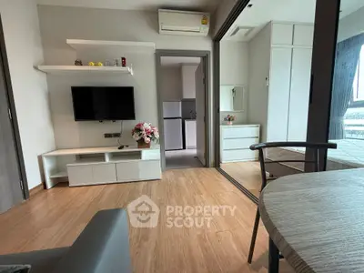 Modern living room with sleek furniture and wooden flooring in a stylish apartment.