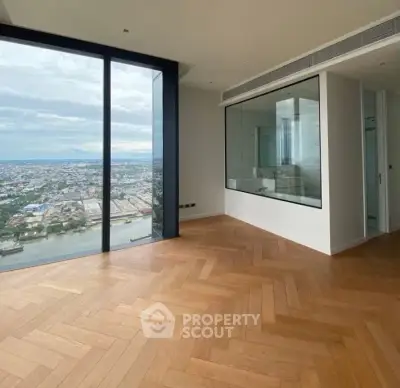 Spacious modern apartment with stunning city view and elegant wooden flooring.