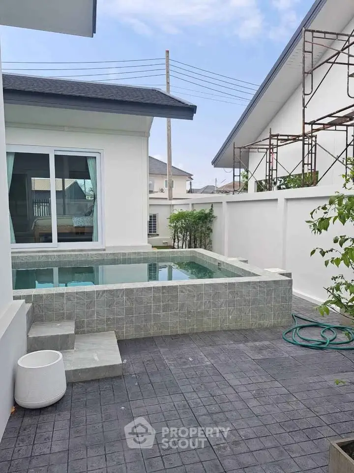 Modern home with private pool and stylish exterior in a serene neighborhood.