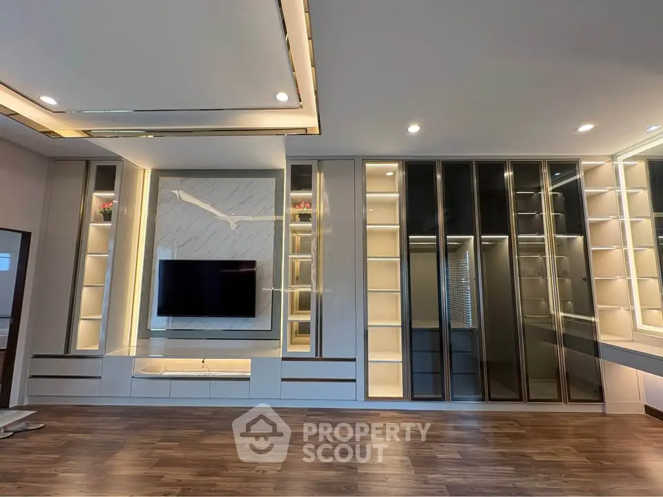 Luxurious modern living room with built-in shelving and sleek TV setup
