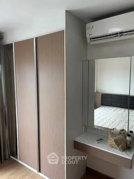 Modern bedroom with sleek wardrobe and air conditioning unit
