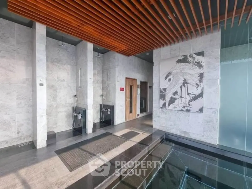 Luxurious spa-like common area with modern design and elegant artwork in a high-end building.