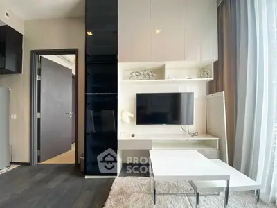 Modern living room with sleek furniture and wall-mounted TV in a stylish apartment.