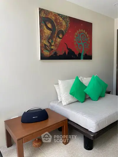 Stylish living room with modern decor and vibrant artwork, featuring a cozy seating area and elegant wooden table.