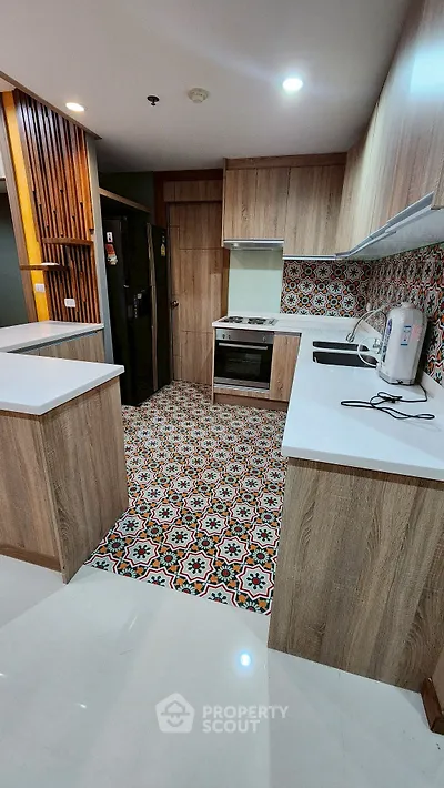 Modern kitchen with stylish patterned tiles and wooden cabinets