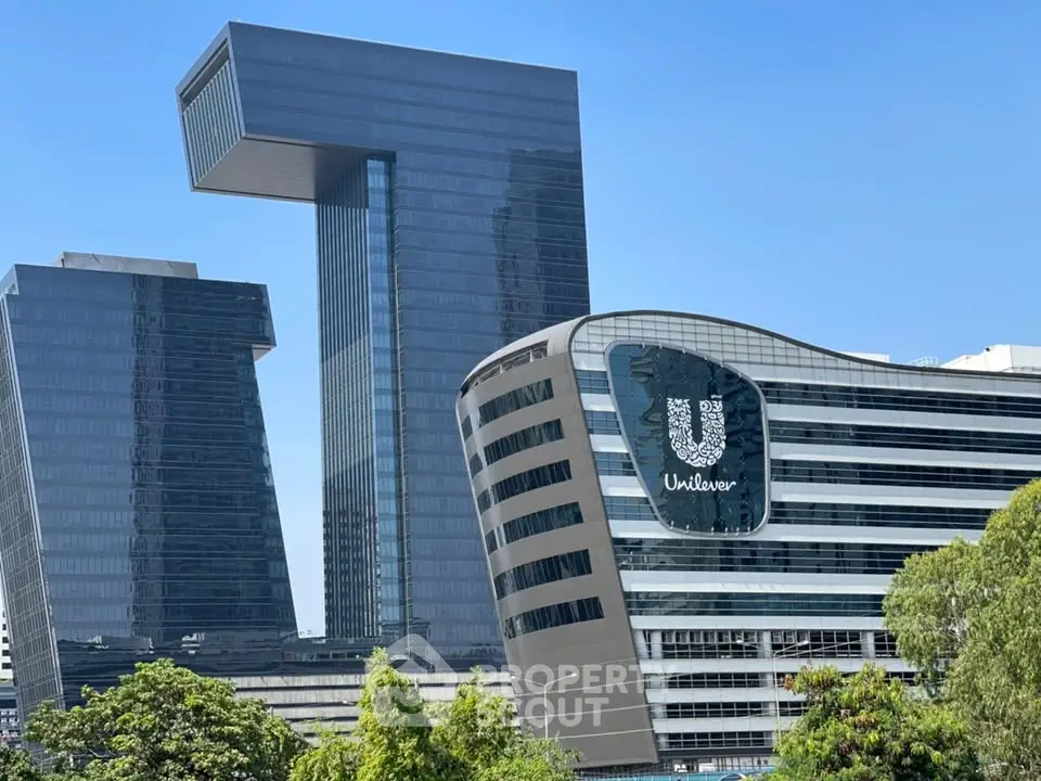 Modern architectural marvels with sleek glass facades and unique structural designs in urban setting.