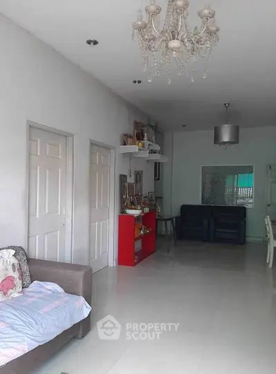 Spacious living room with elegant chandelier and modern decor