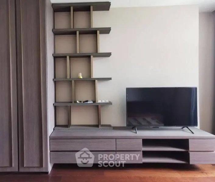 Modern living room with sleek TV stand and built-in shelving, perfect for stylish urban living.