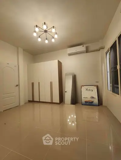 Spacious bedroom with modern lighting and sleek wardrobe