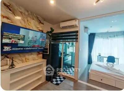 Modern apartment interior with open layout, featuring a cozy living area and a bright bedroom.