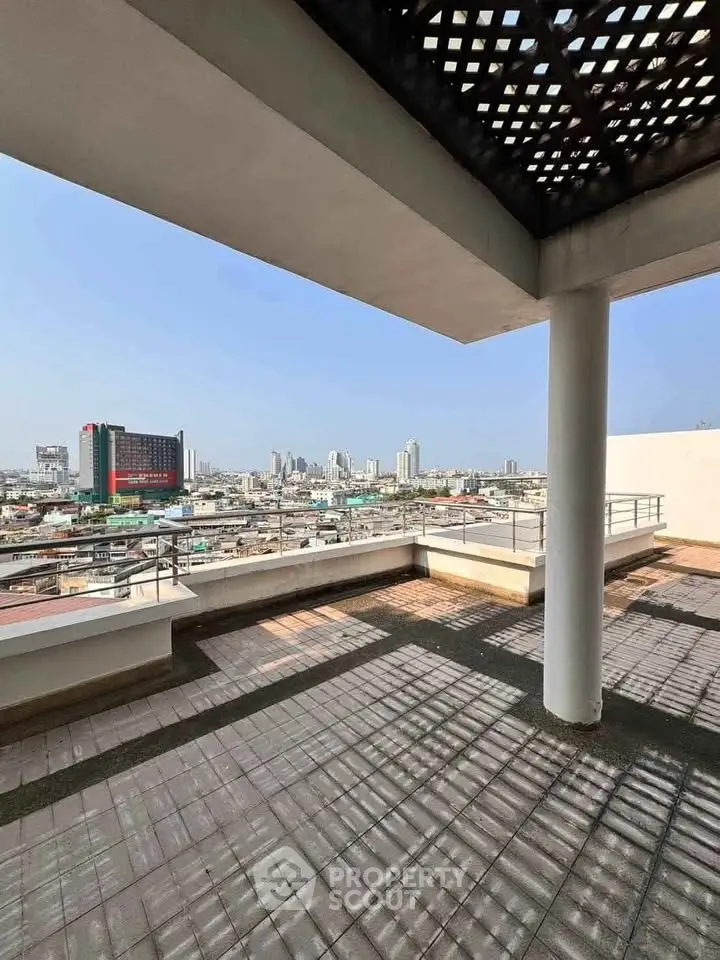Spacious rooftop terrace with stunning city skyline views, perfect for relaxation and entertainment.