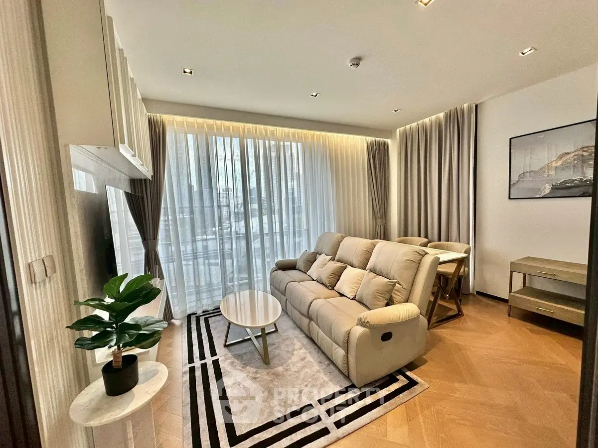 Modern living room with elegant decor and large windows for natural light.