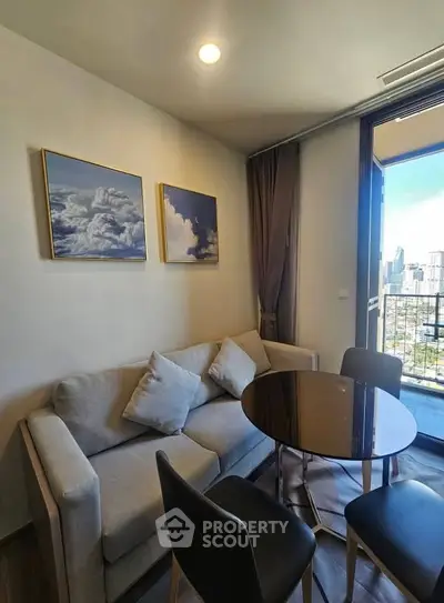 Chic living room with modern decor and city view balcony in urban apartment.