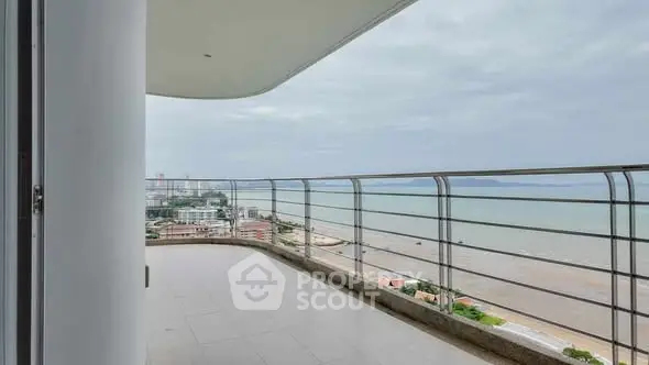 Stunning beachfront balcony with panoramic ocean views in luxury high-rise.