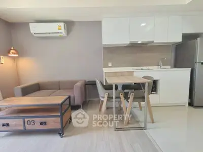 Modern living room with sleek kitchen and stylish furniture