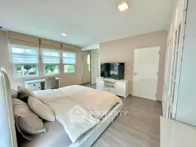 Spacious modern bedroom with large windows and stylish decor