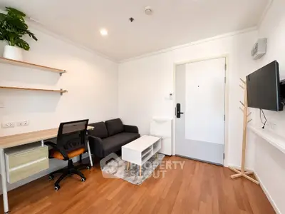Modern living room with sleek furniture and wooden flooring, perfect for a cozy urban lifestyle.