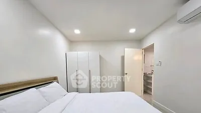 Spacious bedroom with modern wardrobe and air conditioning