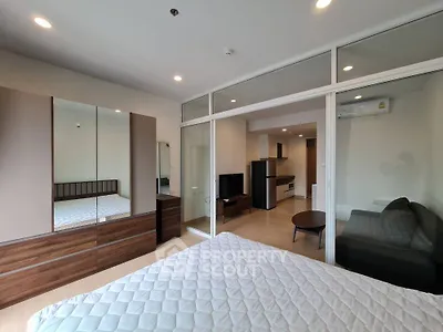 Modern studio apartment with glass partition and stylish furnishings