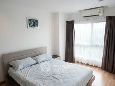 Bright and airy bedroom with large window and modern decor