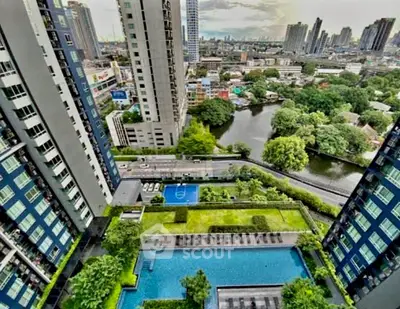 Stunning aerial view of modern high-rise buildings with lush gardens and a sparkling pool, offering a vibrant urban lifestyle.