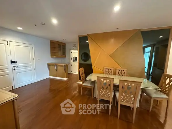 Spacious dining area with elegant wooden flooring and modern design elements.