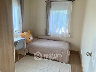 Cozy bedroom with plush bear decor and natural light