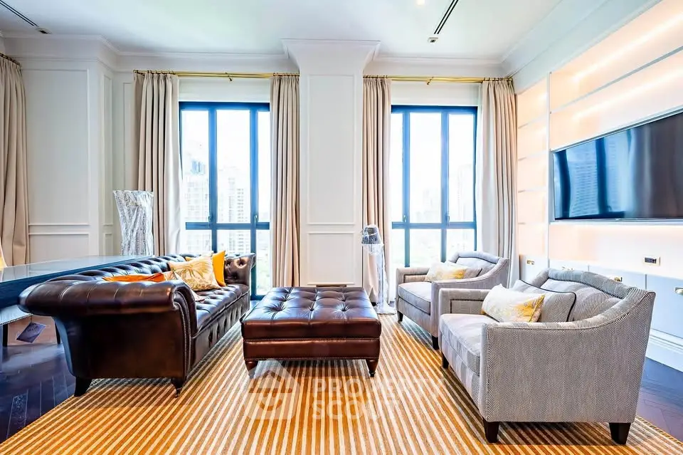 Luxurious living room with elegant furniture and large windows offering city views.