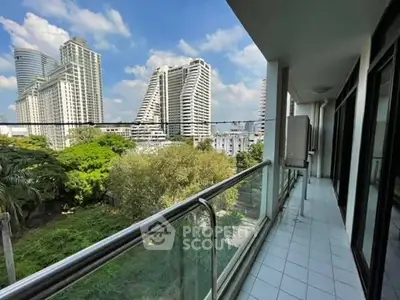 Spacious balcony with stunning cityscape view in modern high-rise building.