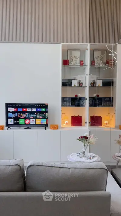 Modern living room with stylish shelving and smart TV setup