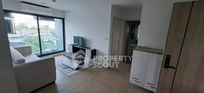 Modern living room with large window and stylish furniture in a contemporary apartment.