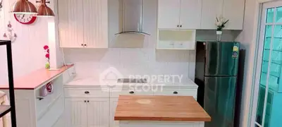 Charming kitchen with modern appliances and stylish white cabinetry