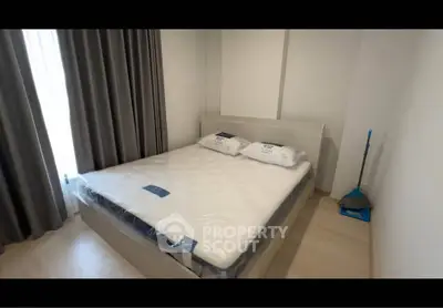 Modern bedroom with cozy bed and elegant curtains in a stylish apartment.