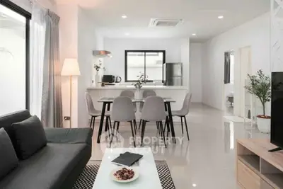 Modern open-plan living and dining area with sleek kitchen and stylish decor