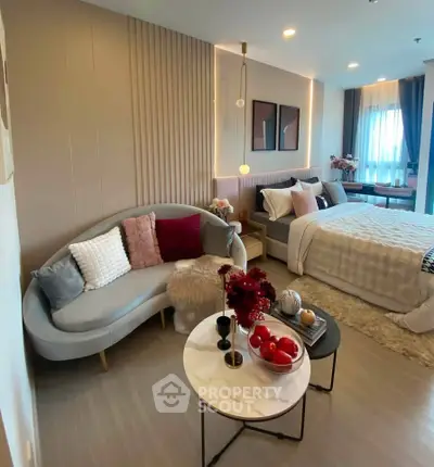 Stylish modern bedroom with cozy seating area and elegant decor