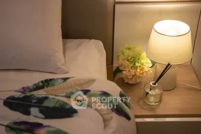 Cozy bedroom with elegant bedside lamp and floral decor