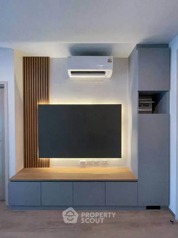 Modern living room with sleek built-in storage and air conditioning unit
