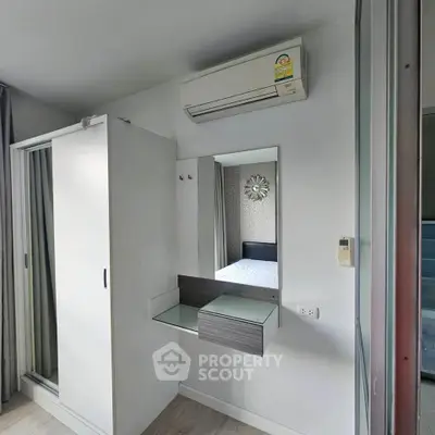 Modern bedroom with sleek wardrobe and air conditioning unit