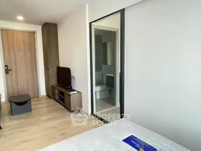 Modern bedroom with ensuite bathroom and sleek wooden furniture